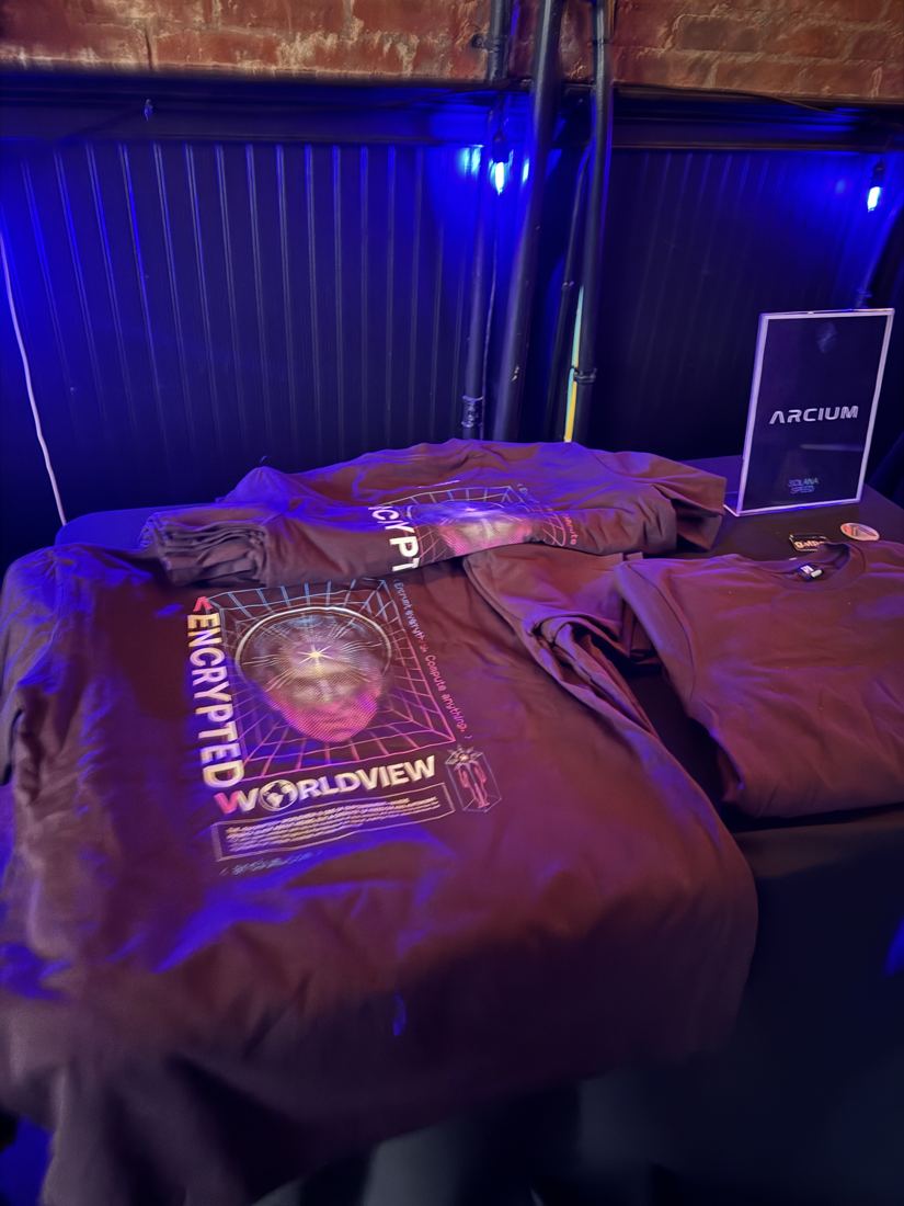 Encrypted Worldview t-shirts on a table under blue light